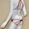 A mannequin wearing a red string bikini.