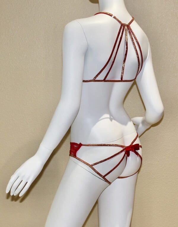 A mannequin wearing a red string bikini.