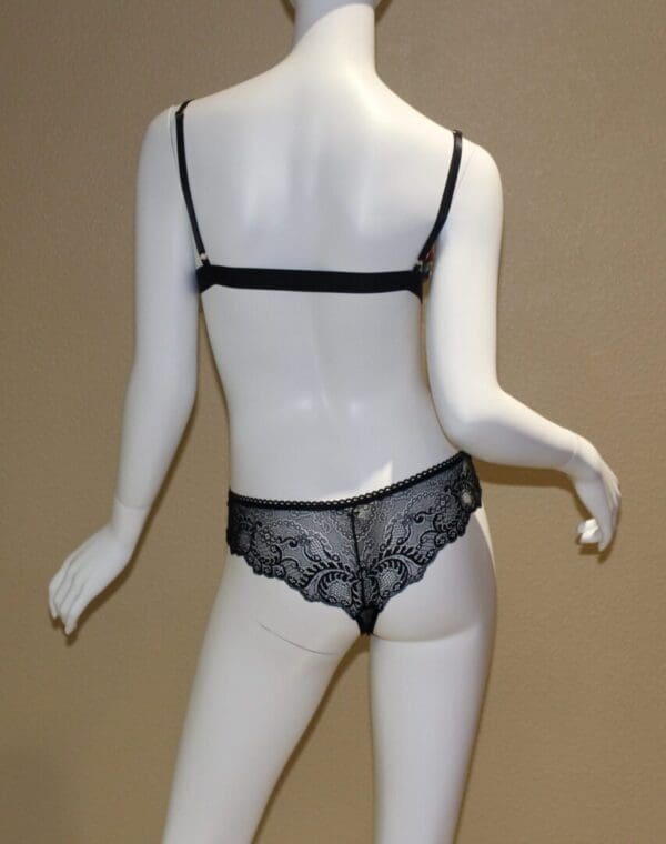 A mannequin wearing lingerie in the middle of a room.