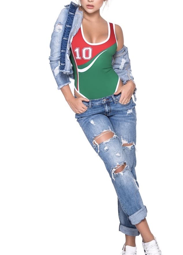 A woman in ripped jeans and green top.