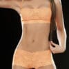 A woman in orange lingerie posing for the camera.