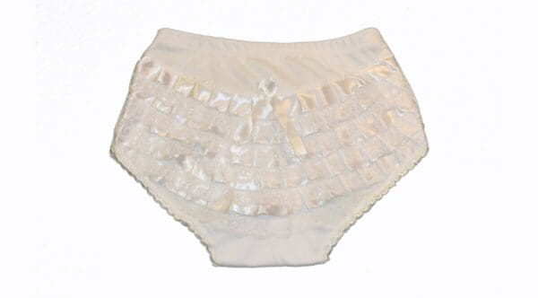 A white ruffle diaper cover with shiny trim.