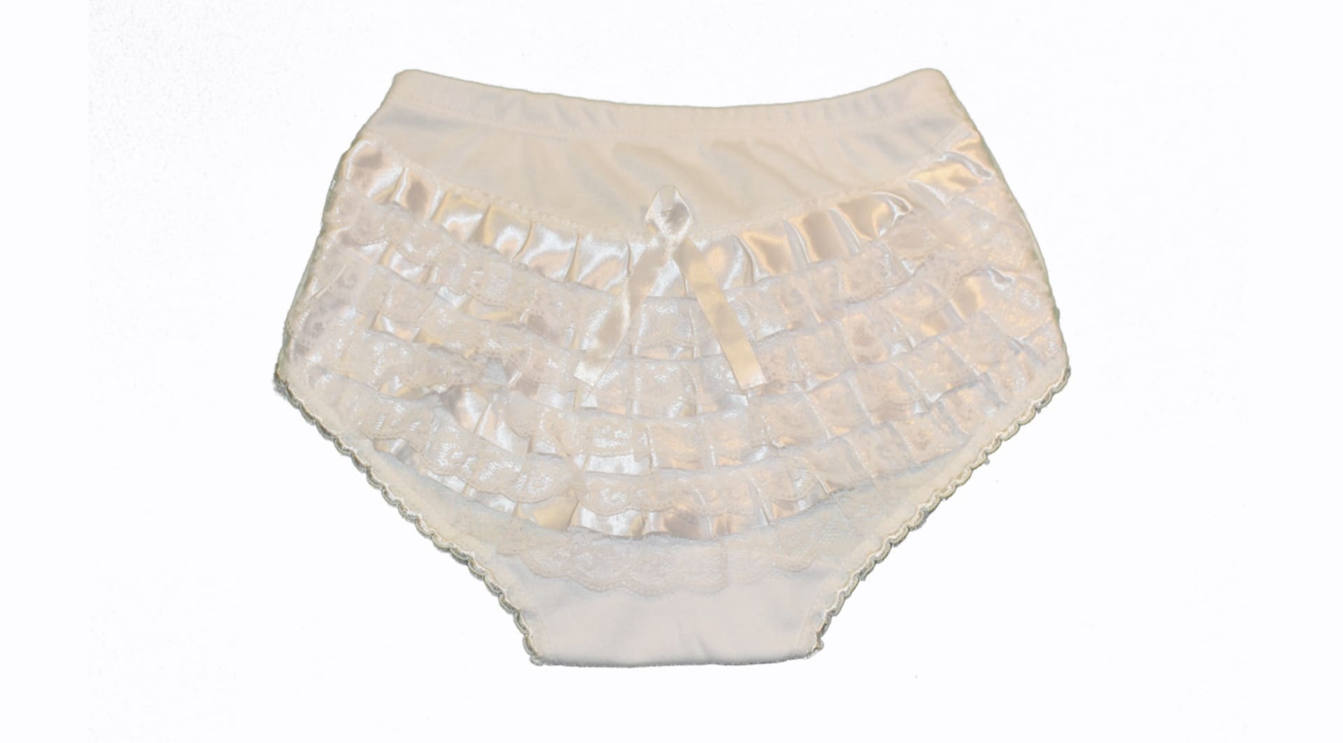 A white ruffle diaper cover with shiny trim.