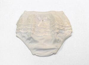 A white diaper with ruffles on it.