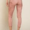 A woman wearing pink pants and shoes