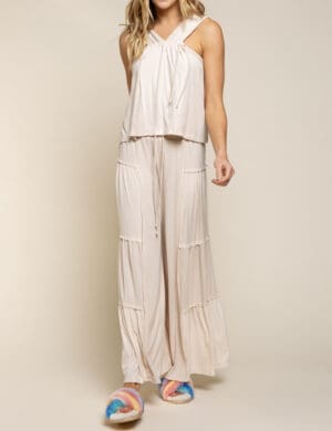 A woman standing in front of a white wall.