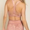 A woman wearing a pink bra and matching skirt.