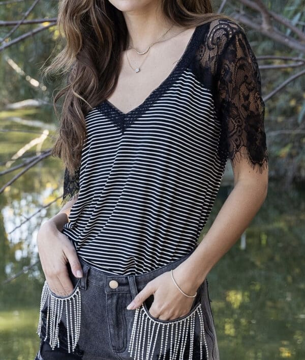 A woman wearing black and white striped top.