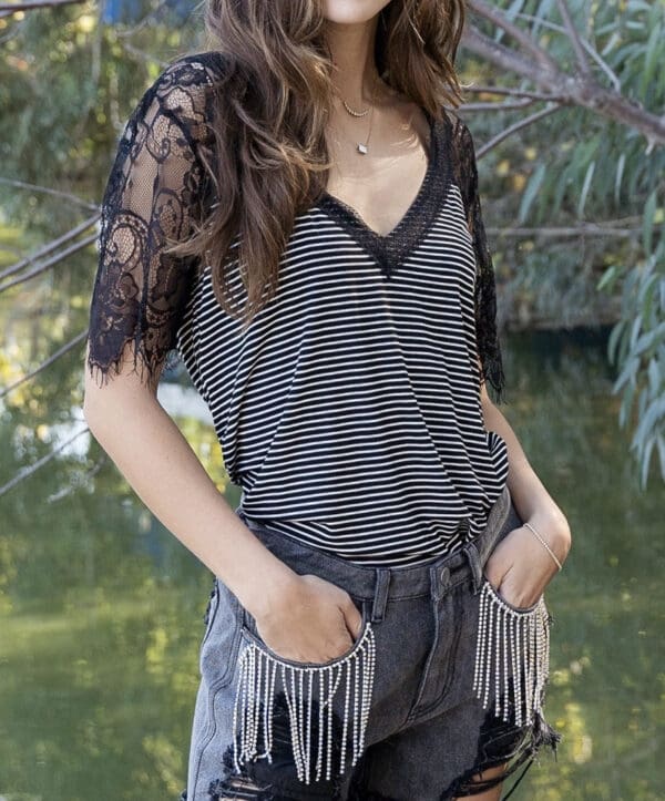 A woman wearing black and white striped shirt