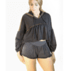 A woman wearing black shorts and a hoodie.