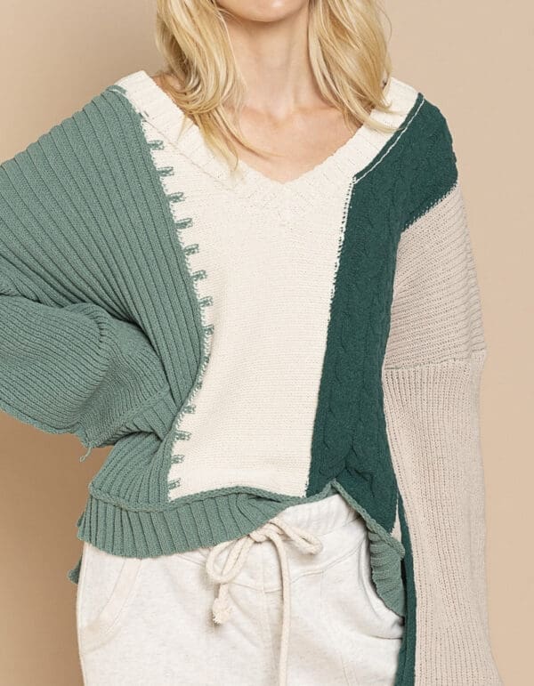 A woman wearing a green and white sweater.