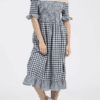 A woman in a dress standing on the ground