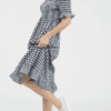 A woman in a dress is standing up
