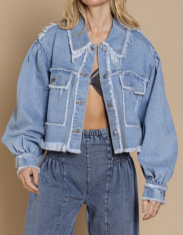 A woman wearing a jean jacket and jeans.