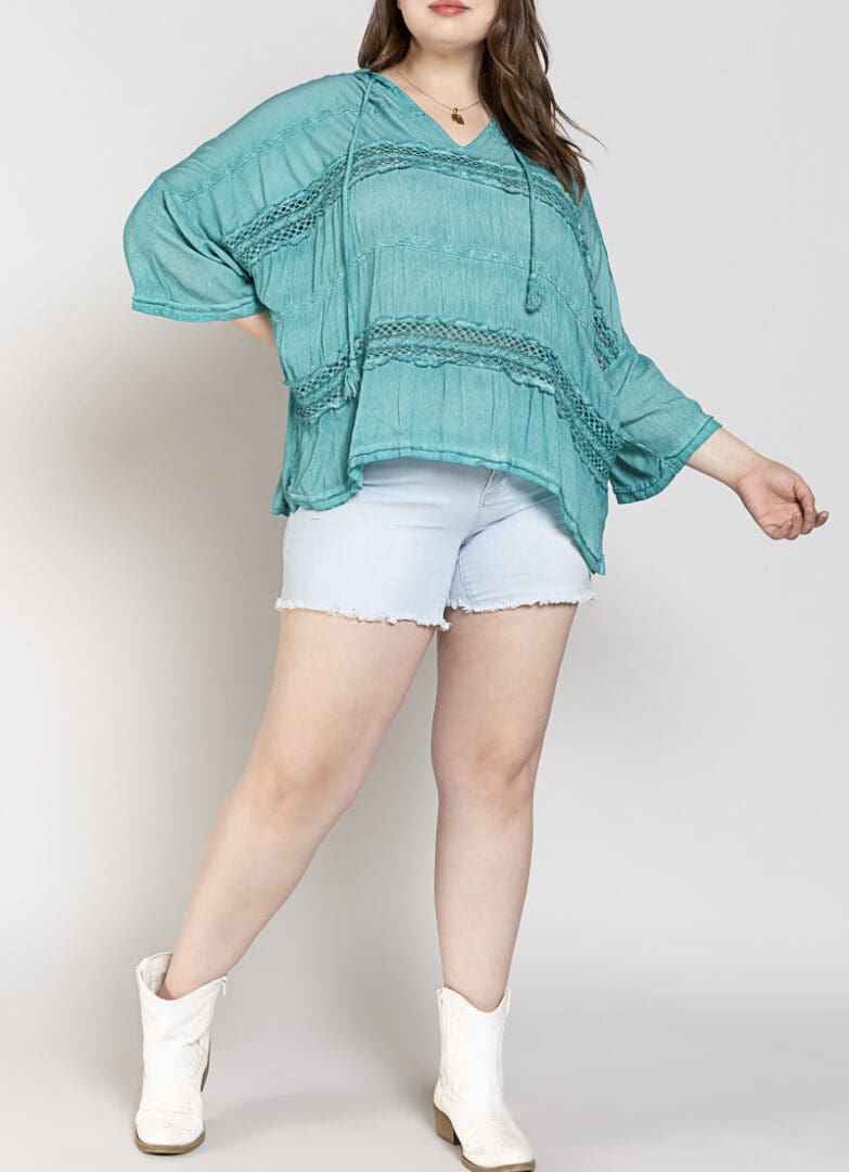 A woman in white shorts and a blue top.