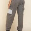 A woman wearing grey sweatpants with pockets.