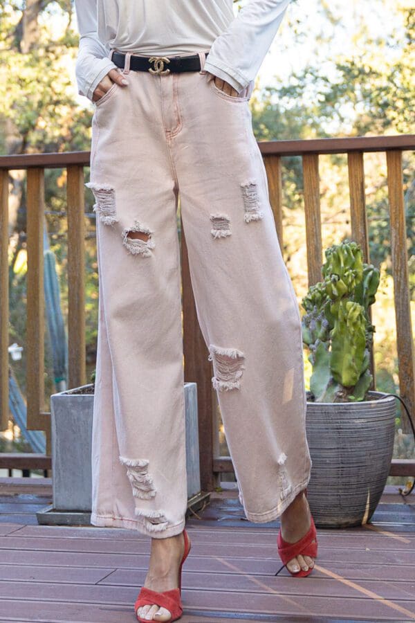 A person standing on top of a wooden deck.