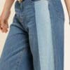 A close up of the side of a person wearing jeans