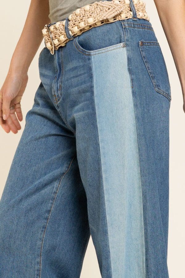 A close up of the side of a person wearing jeans