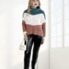 Woman in color-block sweater and boots.
