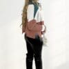 Woman in color-block sweater and boots.