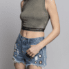 A woman wearing denim shorts and a crop top.