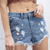 A woman is wearing jean shorts with holes.