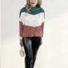 Woman in color-blocked sweater and boots.