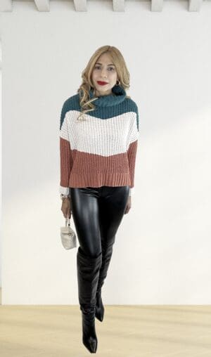Woman in color-blocked sweater and boots.