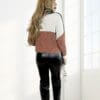 Woman in color-blocked sweater and boots.