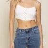 A woman wearing jeans and white top