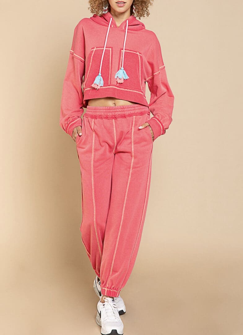 A woman in pink pants and a hoodie.