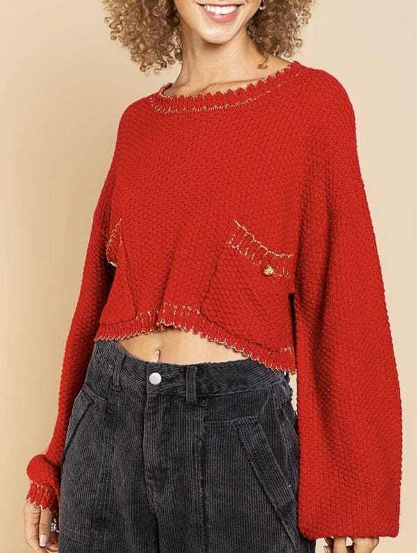 A woman wearing jeans and red sweater.