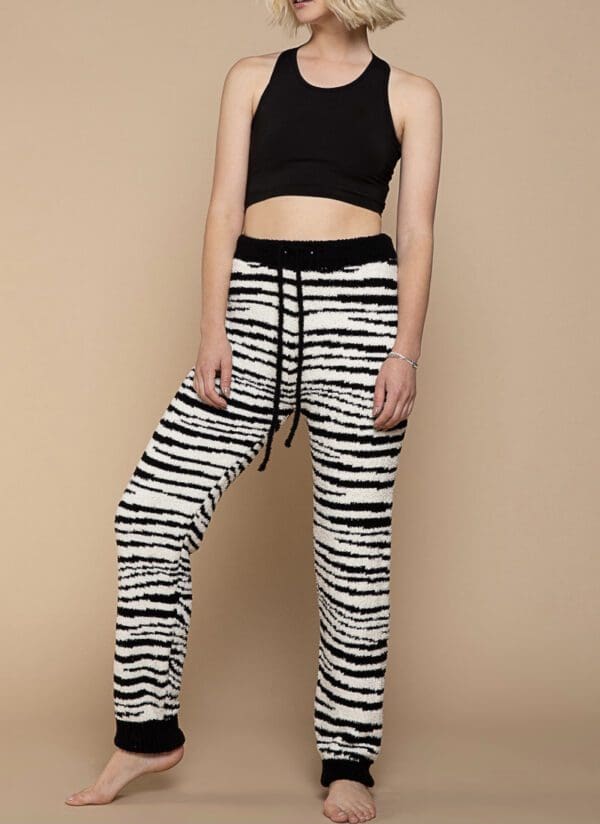 A woman wearing black and white striped pants.