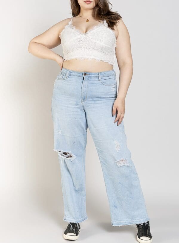 A woman wearing jeans and a bra top