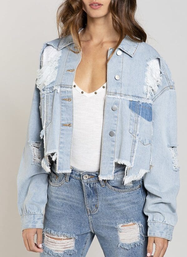 A woman wearing a jean jacket and jeans.