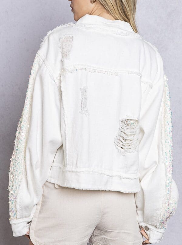 A white jacket with some patches on it