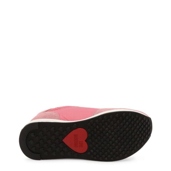 A pair of shoes with red hearts on them.