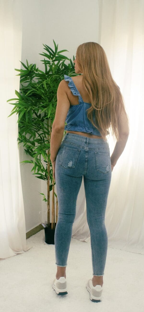 A woman in blue jeans and a white shirt