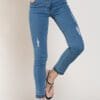 A woman in blue jeans and black sandals