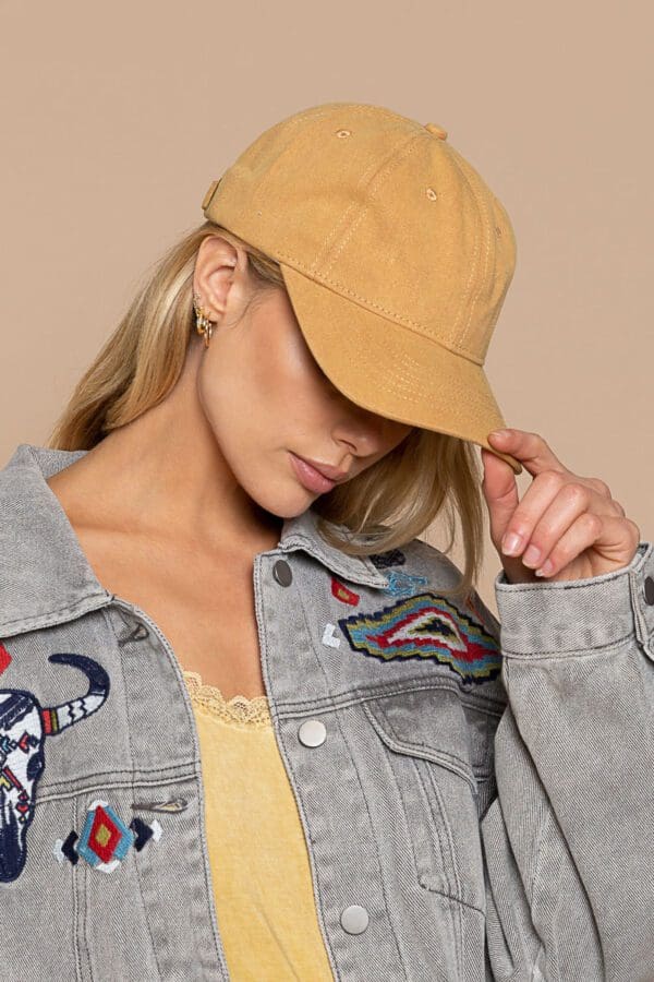 A woman in yellow hat and jean jacket.