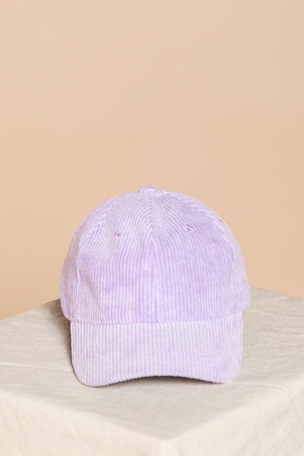 A purple hat is sitting on the ground