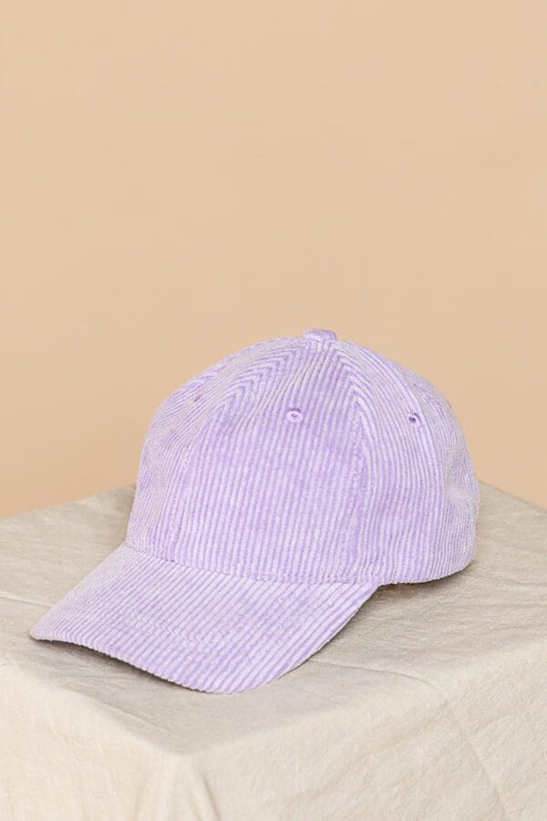 A purple hat sitting on top of a table.