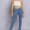 A woman wearing jeans and a white top