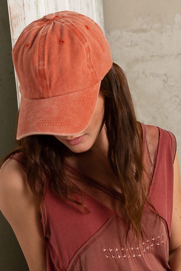 A woman wearing an orange hat and red dress.