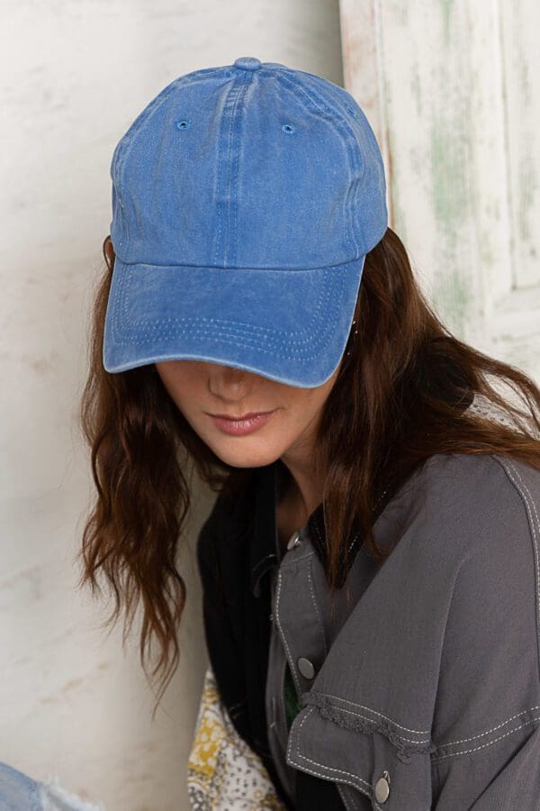 A woman wearing a blue hat and black tie.