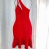 A red dress hanging on the wall