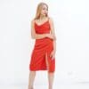 A woman in red dress posing for the camera.