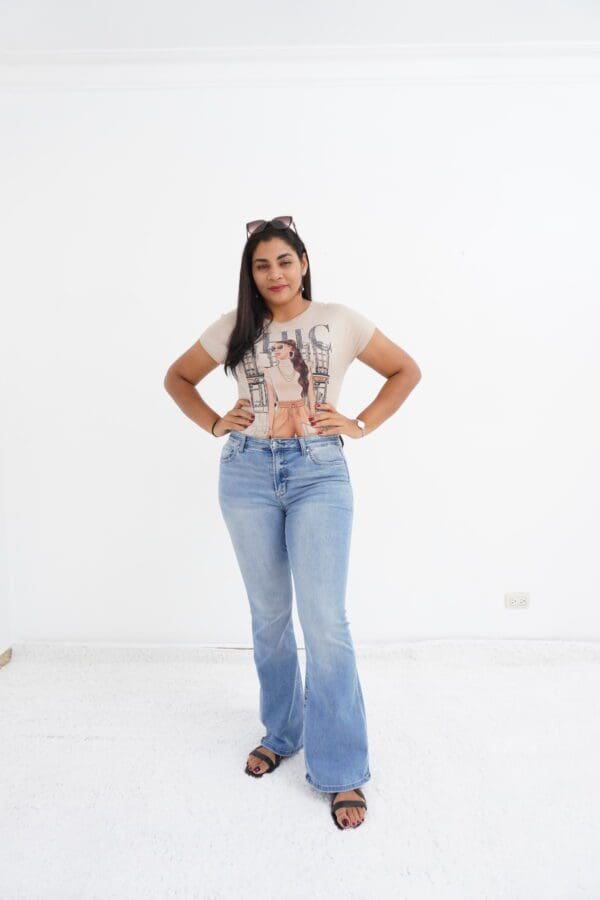 A woman in jeans and a t-shirt posing for the camera.