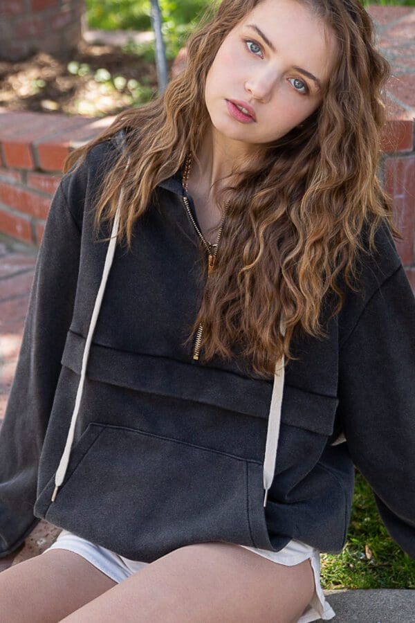 A woman with long hair and a black jacket.